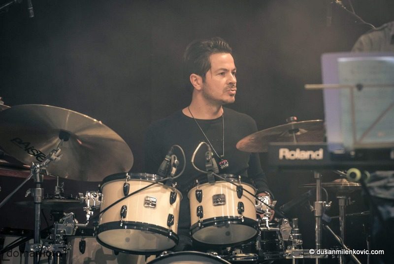 Dušan Milenković playing drums live on stage